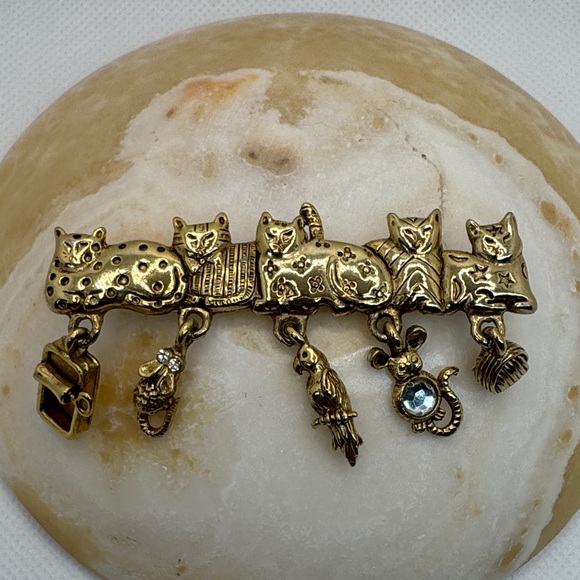 AJC Jewelry - AJC Vintage gold-tone brooch with five cats and dangling charms.